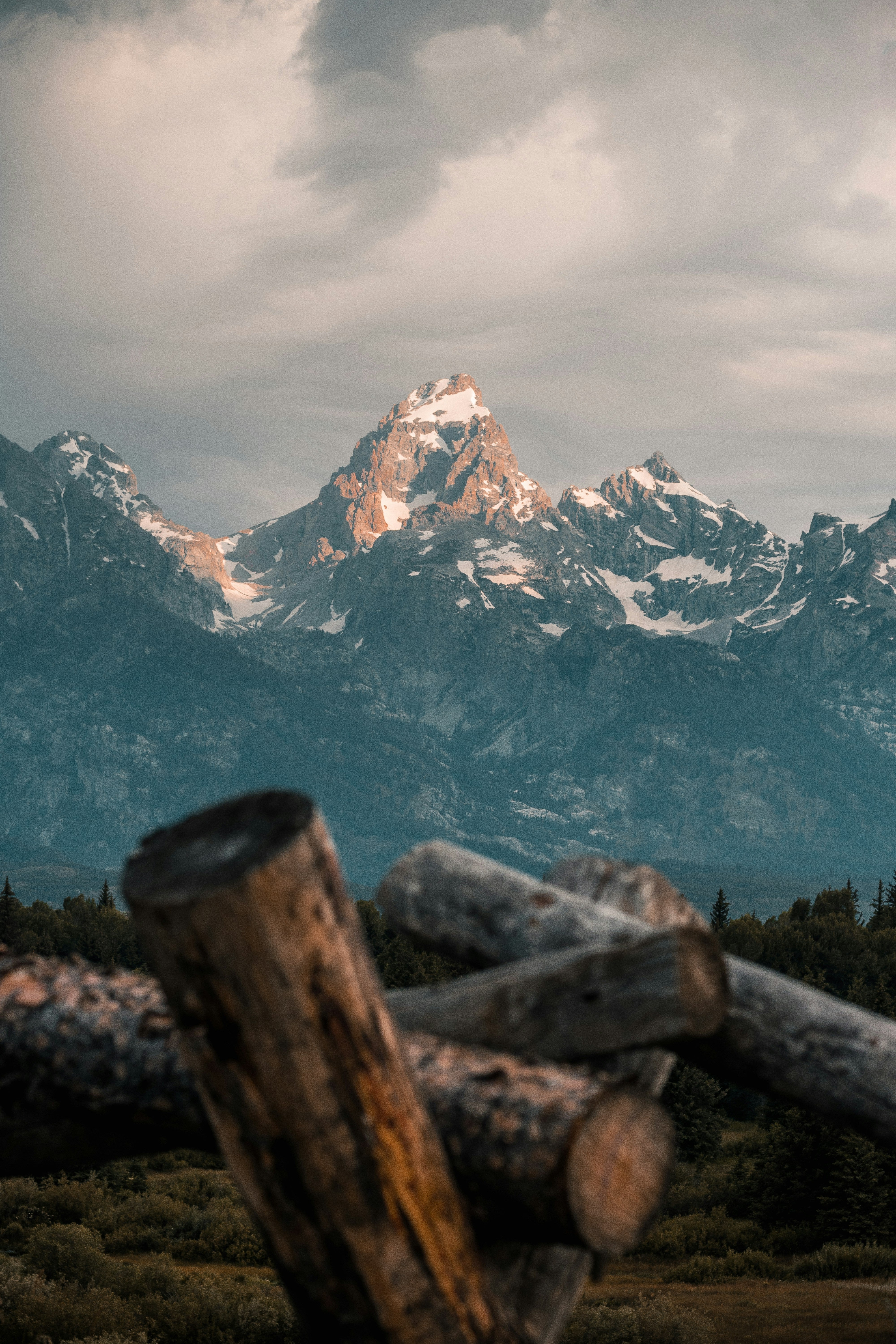 “Grand Tetons seen from rustic log fence, Teton Valley, photo by Ben Emrick.”