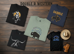 “Banner for Double R Western T-SHOP featuring five folded western t-shirts: bull rider graphic, SADDLE bronc rider, Grand Tetons bison, realistic bull, and neon Bison Strong bison shirt, all arranged on a rustic wood background.