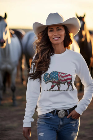 Woman wearing a Bison Americana long sleeve t-shirt with horses in the background