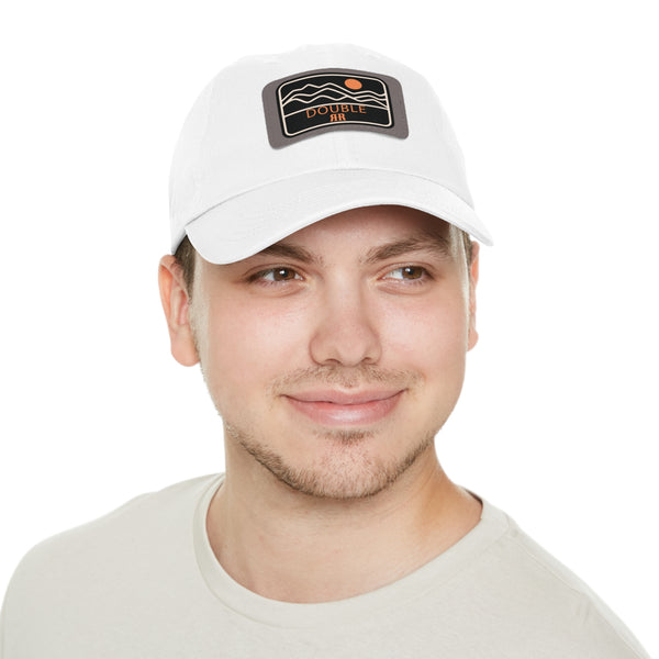 White dad hat on model, centered rectangle leather logo patch