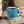 Blue enamel camp mug with black rim, white bottom, and 'Around & Find Out' text