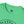 Green crewneck T-shirt with small chest logo patch at neckline and top of graphic