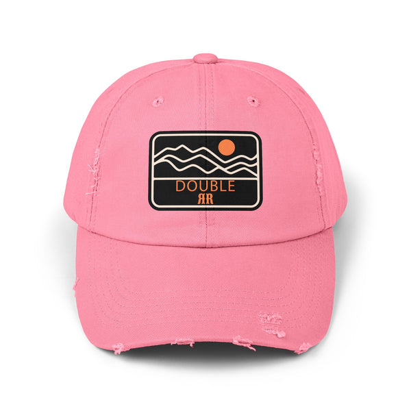 True pink distressed dad hat with front patch logo and worn, frayed brim