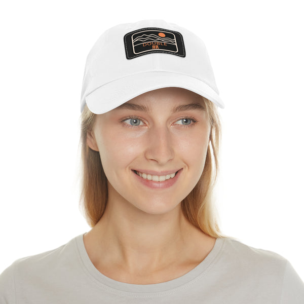 White dad hat on model, rectangle leather logo patch