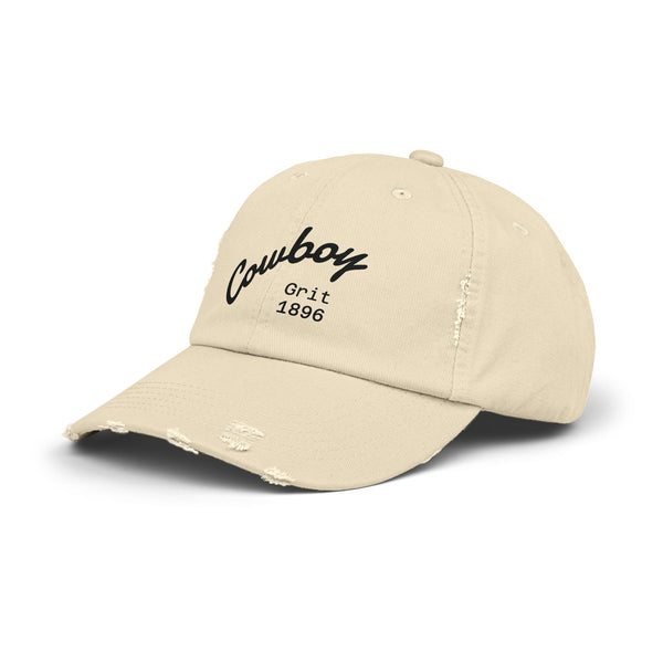Distressed dad hat in light beige with Cowboy Grit 1896 logo on front, side view