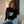 Black women's cropped hooded sweatshirt with front graphic and long sleeves