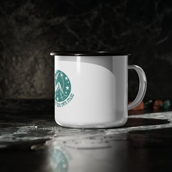 Enamel camp mug close-up: white body with green star graphic, black rim, side handle.