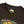 Dark brown T-shirt crew neck with logo label and top of graphic