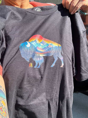 customer holding our bison landscape tee shirt in the sun