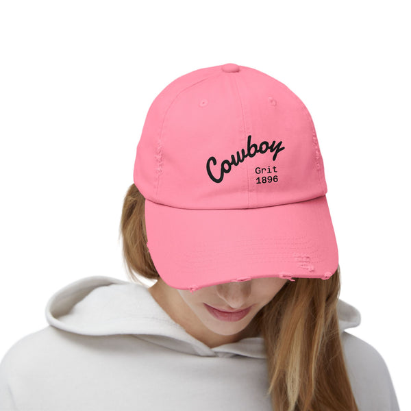 True Pink distressed dad hat on model with Cowboy Grit 1896 logo on side