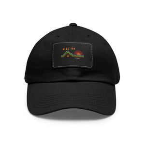 Black dad hat with rectangular leather patch front, curved brim and stitched logo