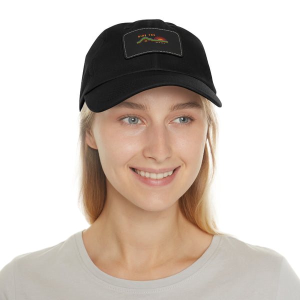 Black dad hat worn by model, rectangular leather patch on front