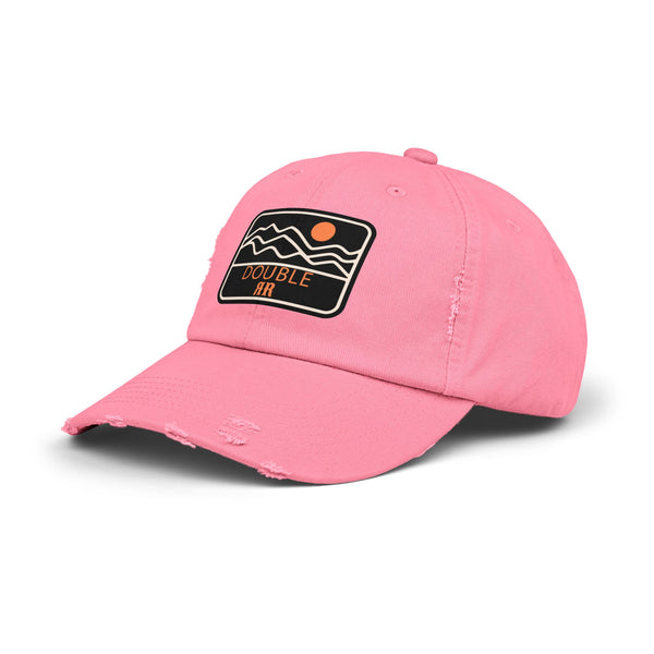 Pink distressed dad hat with front logo patch and curved brim
