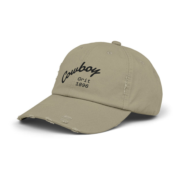 Distressed dad hat in light beige with Cowboy Grit 1896 logo on front, side view