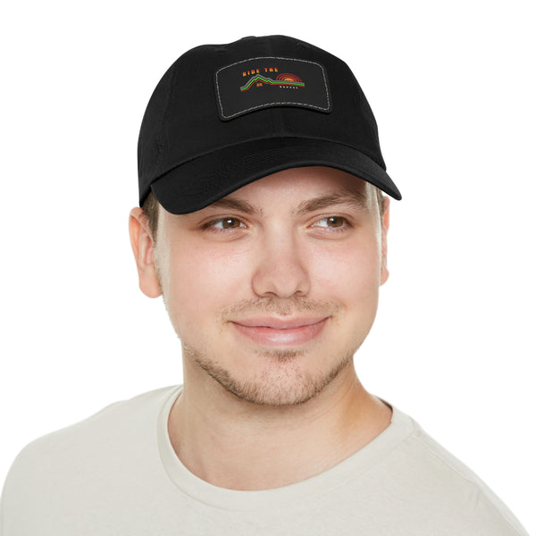 Black dad hat worn by model with rectangular leather patch front detail