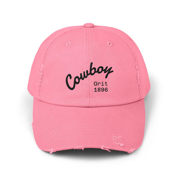 Distressed dad hat in true pink with Cowboy Grit 1896 logo on front