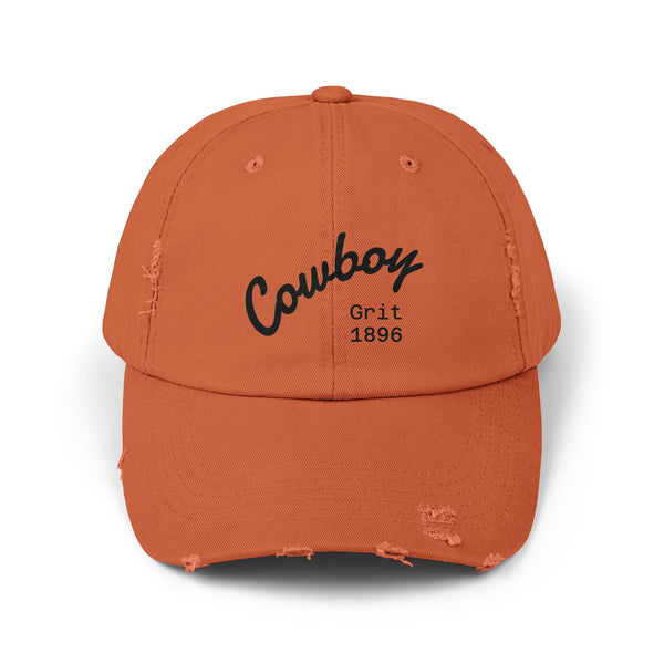 Distressed dad hat in burnt orange with Cowboy Grit 1896 logo stitched on front