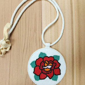 “Native American handmade western art medallion by Anita Setzer with shiny, faceted cut bead beadwork.”