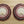 Pair of beaded bear claw earrings, oval maroon-and-white beadwork with white paw print cabochon.