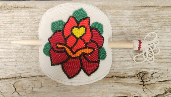 Beaded rose barrette with red flower and green leaves on round white bead backing