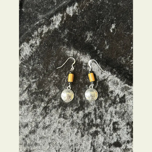 Buffalo nickel and yellow trade bead earrings, Little Brother Edition, handcrafted by Amie Loiselle with silver-plated hooks, displayed on a black velvet background.