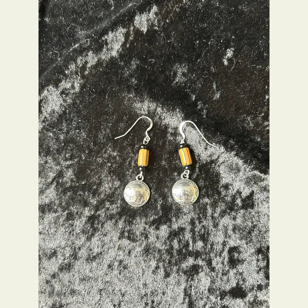 Buffalo nickel and yellow trade bead earrings, Little Brother Edition, handcrafted by Amie Loiselle with silver-plated hooks, displayed on a black velvet background.