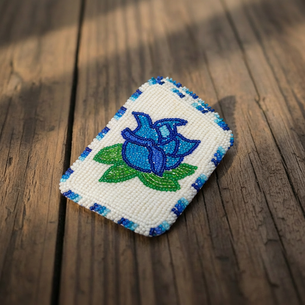Hand-beaded blue rose card holder with green leaves on a white beaded background.
