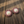 Beaded bear claw earrings with oval maroon and white beadwork and a white paw print center.