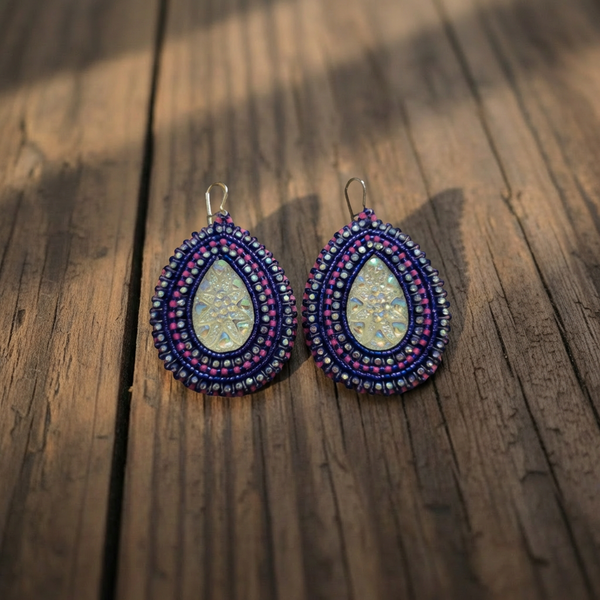 Beaded teardrop earrings with blue, pink, and gold beadwork and gold-toned center