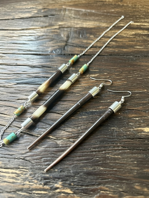 
Handcrafted African porcupine quill necklace and matching earrings set by Amie Loiselle, featuring sterling silver chain and colorful trade beads on a black velvet background.