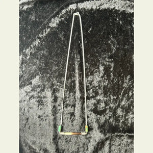 Handcrafted necklace featuring an African porcupine quill bar with turquoise beads on a sterling silver chain, displayed on a black velvet background.
