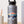 Glossy bison sticker on a matte silver water bottle with mountain and pine scene